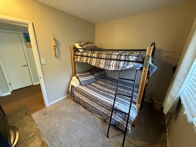 carpeted bedroom featuring baseboards