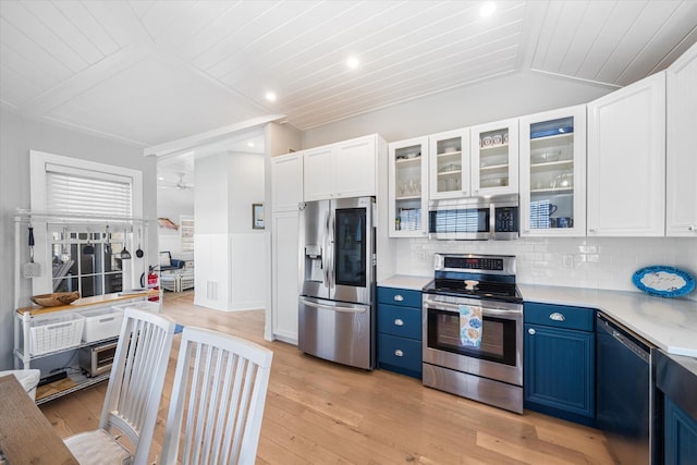 kitchen with stainless steel appliances, wooden ceiling, light countertops, blue cabinetry, and white cabinets