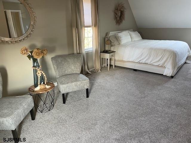 carpeted bedroom with vaulted ceiling