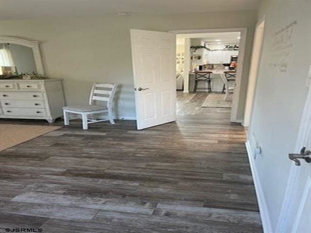 corridor with dark wood-type flooring