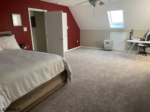 bedroom featuring vaulted ceiling, ceiling fan, and carpet