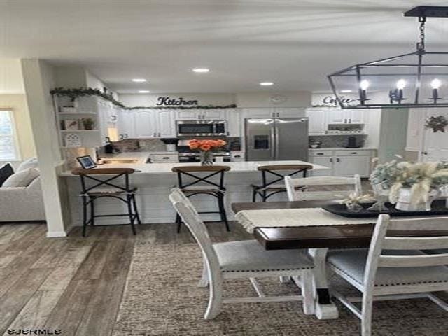 dining space featuring dark hardwood / wood-style flooring