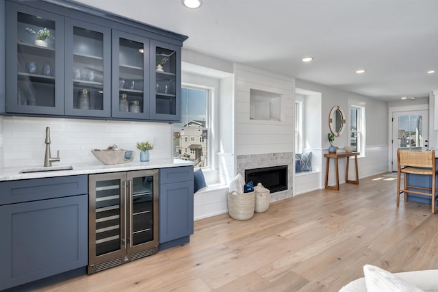 599 22nd St Unit 599, Avalon, NJ 08202 - bar area featuring beverage cooler, light wood finished floors, decorative backsplash, recessed lighting, and a fireplace