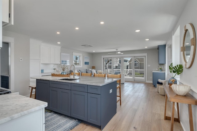 599 22nd St Unit 599, Avalon, NJ 08202 - kitchen featuring a breakfast bar, white cabinets, light wood-style floors, a ceiling fan, and recessed lighting