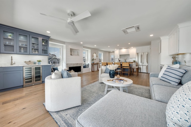 599 22nd St Unit 599, Avalon, NJ 08202 - living room featuring beverage cooler, bar with sink, light wood finished floors, a ceiling fan, and recessed lighting