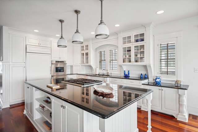73 E 25th St, Avalon, NJ 08202 - kitchen featuring stainless steel double oven, a center island, healthy amount of natural light, white cabinetry, and recessed lighting