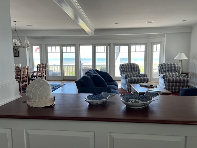 73 E 25th St, Avalon, NJ 08202 - living area featuring crown molding, healthy amount of natural light, a chandelier, beamed ceiling, and wood finished floors