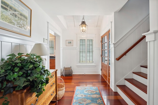 73 E 25th St, Avalon, NJ 08202 - entrance foyer with stairway, dark wood-style floors, beamed ceiling, a wainscoted wall, and a decorative wall