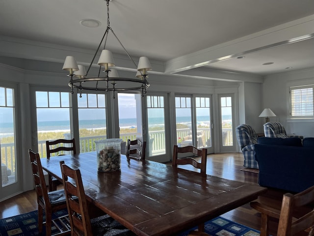 73 E 25th St, Avalon, NJ 08202 - dining area featuring wood finished floors, a chandelier, crown molding, and a water view