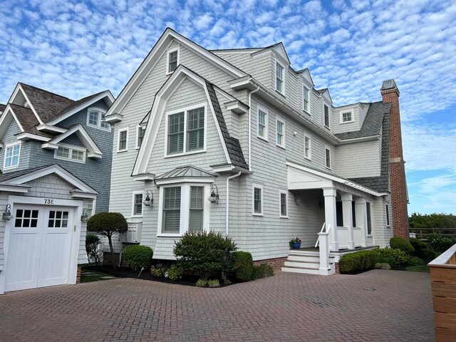 73 E 25th St, Avalon, NJ 08202 - shingle-style home with decorative driveway, a garage, and a chimney