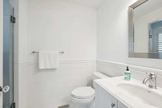 73 E 25th St, Avalon, NJ 08202 - bathroom featuring vanity, a wainscoted wall, and tile walls
