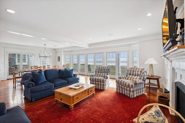 73 E 25th St, Avalon, NJ 08202 - living room featuring wood finished floors, a chandelier, a fireplace, and recessed lighting