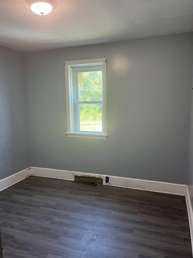 unfurnished room featuring dark hardwood / wood-style flooring