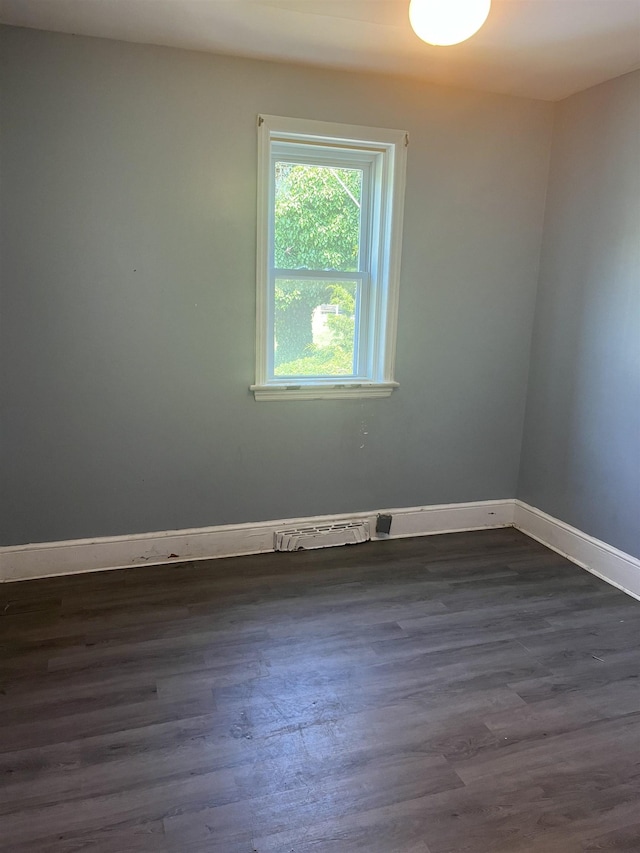 spare room with dark hardwood / wood-style flooring