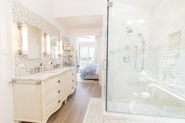 328 83rd St, Stone Harbor, NJ 08247 - bathroom with a shower stall, double vanity, wood finished floors, vaulted ceiling, and tasteful backsplash