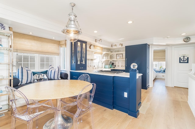 328 83rd St, Stone Harbor, NJ 08247 - kitchen with blue cabinets, open shelves, light wood-type flooring, light countertops, and a peninsula