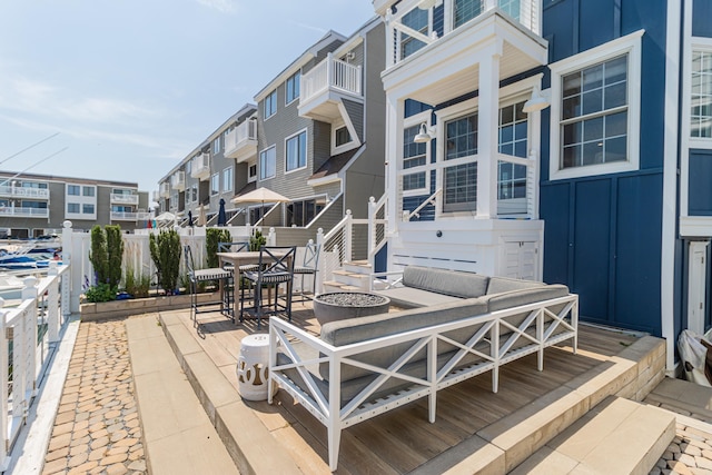 328 83rd St, Stone Harbor, NJ 08247 - wooden terrace with an outdoor living space with a fire pit