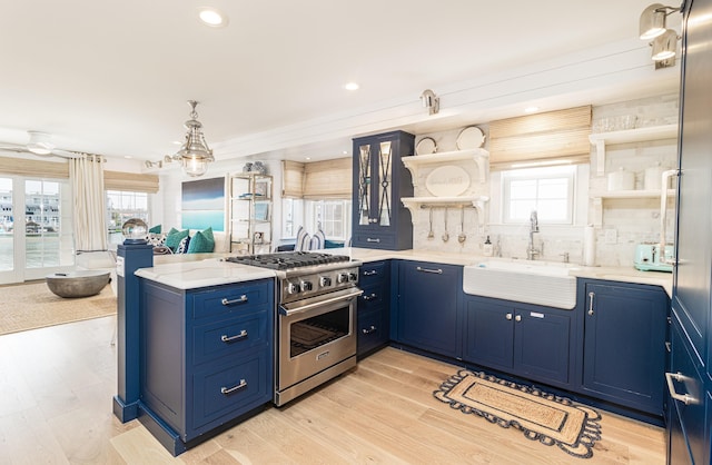 328 83rd St, Stone Harbor, NJ 08247 - kitchen with open shelves, high end range, blue cabinets, a peninsula, and recessed lighting