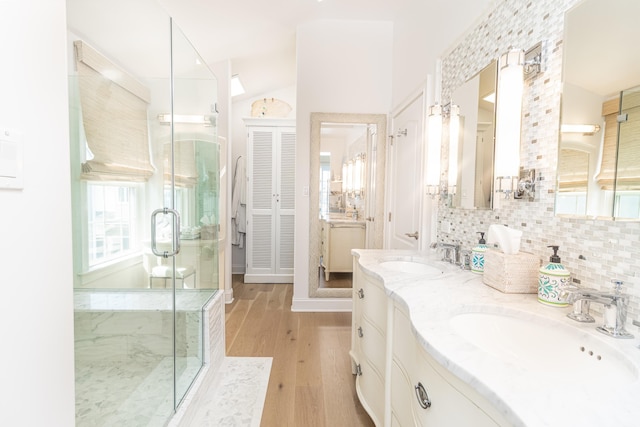 328 83rd St, Stone Harbor, NJ 08247 - bathroom featuring double vanity, a stall shower, wood finished floors, backsplash, and vaulted ceiling
