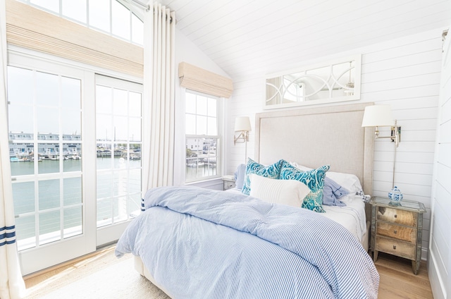 328 83rd St, Stone Harbor, NJ 08247 - bedroom featuring a water view, lofted ceiling, wood finished floors, and wooden walls