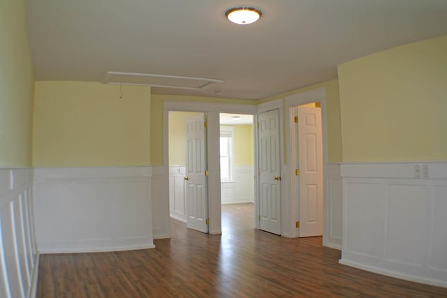 empty room with dark hardwood / wood-style flooring