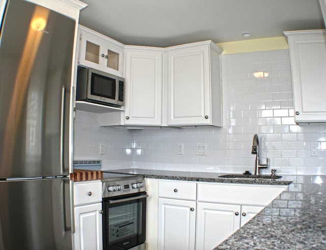 kitchen featuring backsplash, sink, white cabinets, and stainless steel appliances