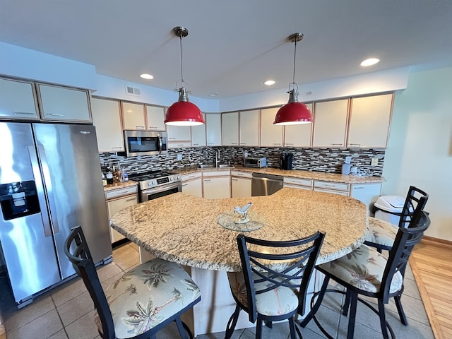9400 Roberts Ave Unit 302, Sea Isle City, NJ 08243 - kitchen with hanging light fixtures, visible vents, tasteful backsplash, and stainless steel appliances
