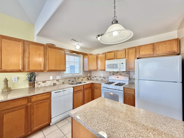 kitchen featuring light tile patterned flooring, sink, pendant lighting, white appliances, and light stone countertops