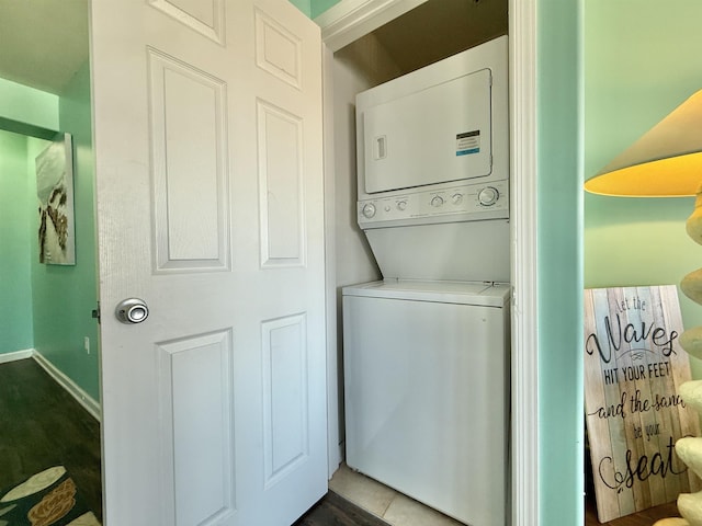 washroom with stacked washer / drying machine