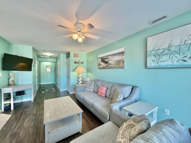 living room with dark wood-type flooring and ceiling fan