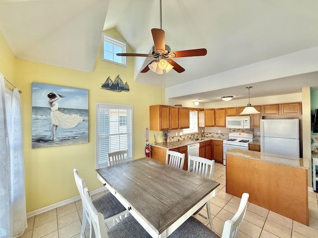 dining space with ceiling fan, high vaulted ceiling, sink, and light tile patterned floors