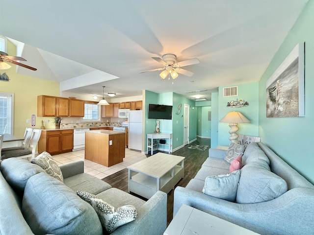 tiled living room with ceiling fan