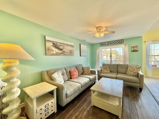 living room with dark wood-type flooring and ceiling fan