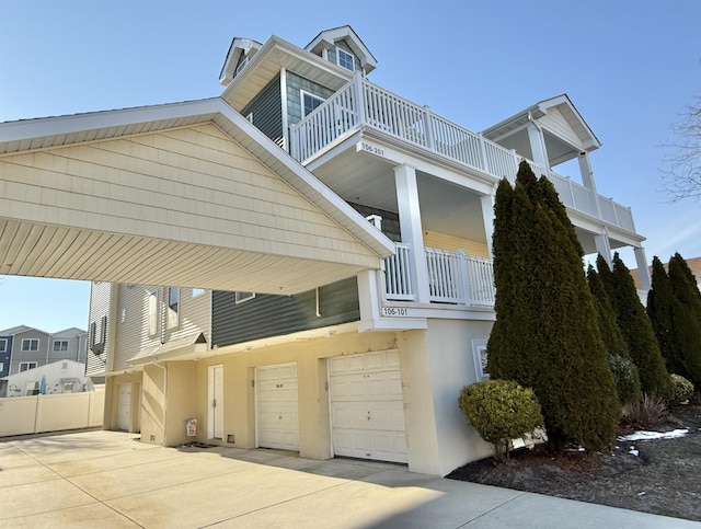 view of property exterior featuring a garage and a balcony