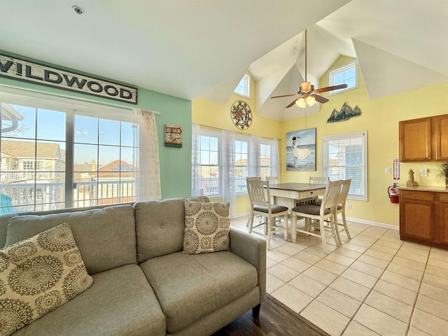 tiled living room with high vaulted ceiling and ceiling fan