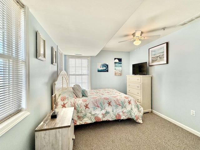 bedroom featuring ceiling fan, carpet, and multiple windows