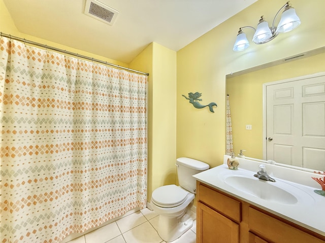 bathroom with vanity, tile patterned floors, toilet, and walk in shower