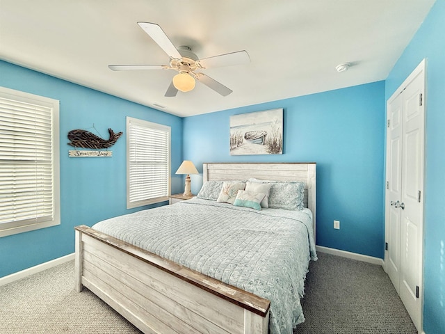 carpeted bedroom featuring ceiling fan and a closet