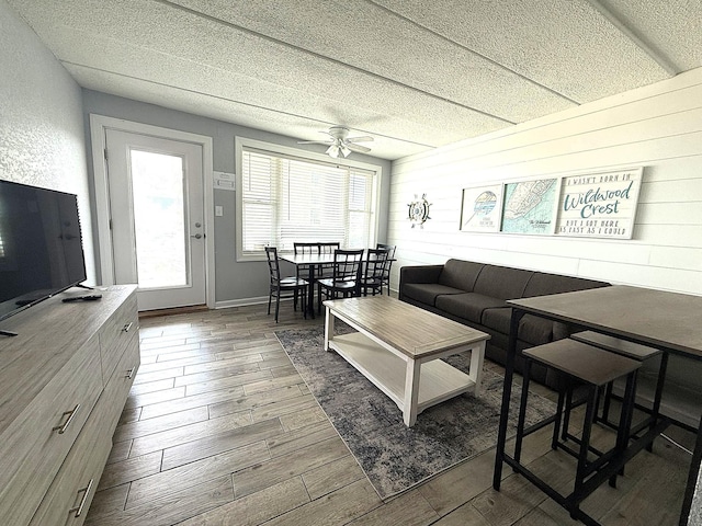 9103 Atlantic Ave Unit 413, Wildwood Crest, NJ 08260 - living area featuring wood finished floors, a ceiling fan, and wood walls