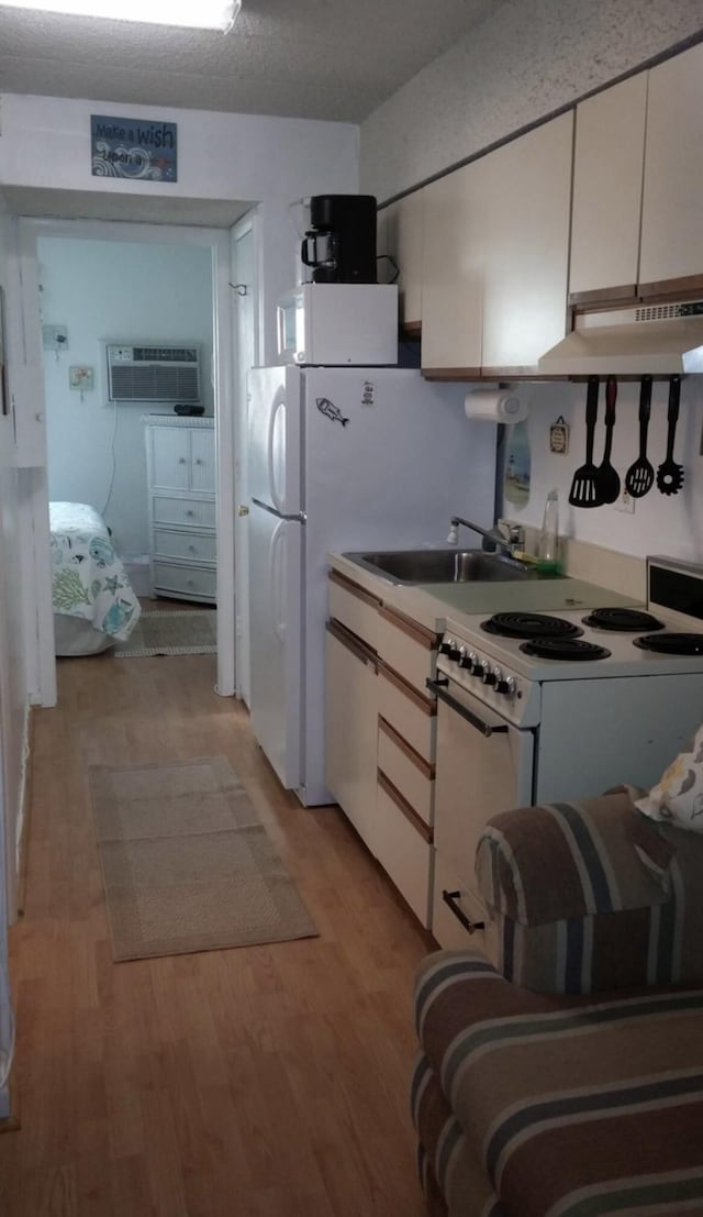 kitchen featuring light wood-style floors, electric range, white cabinetry, and under cabinet range hood