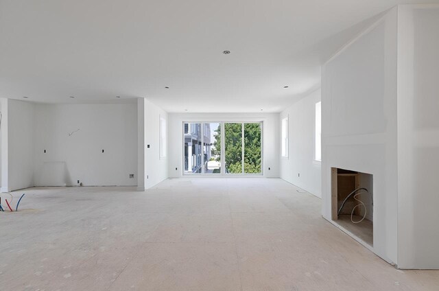 3 Mace Ave Unit A, North Wildwood, NJ 08260 - unfurnished living room with concrete flooring and a fireplace