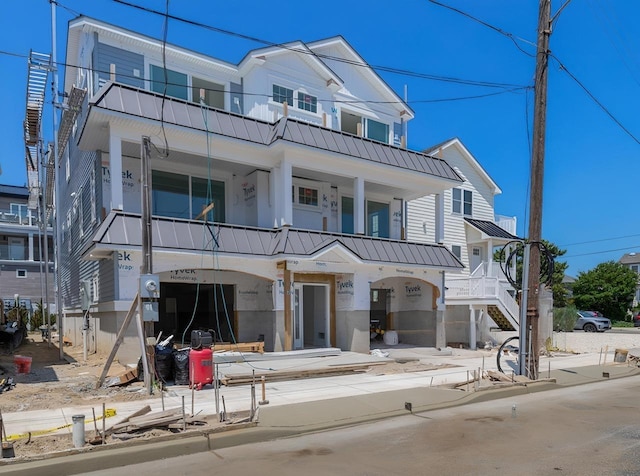 3 Mace Ave Unit A, North Wildwood, NJ 08260 - view of front of property with a balcony, a standing seam roof, a metal roof, and stucco siding
