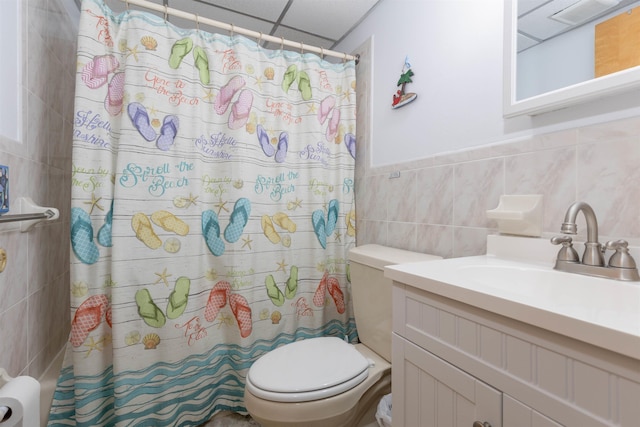 full bath featuring tile walls, vanity, a shower with shower curtain, and toilet