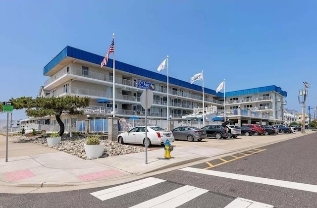 view of building exterior with uncovered parking