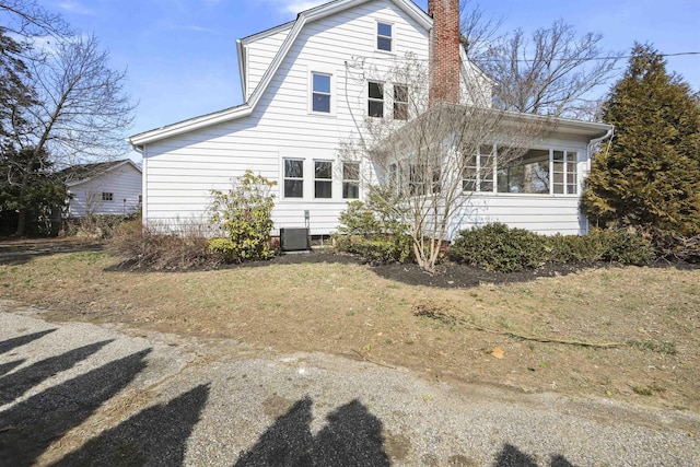 back of house with a chimney