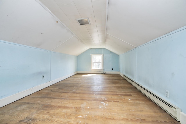 bonus room featuring light wood finished floors, baseboard heating, and lofted ceiling