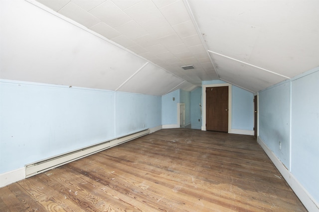 additional living space featuring hardwood / wood-style flooring, lofted ceiling, and a baseboard radiator