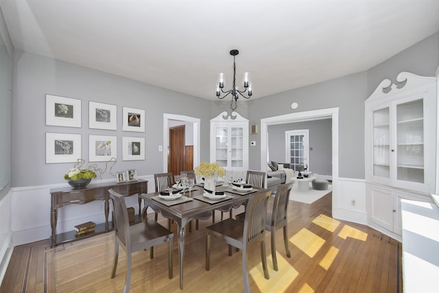 dining room featuring a notable chandelier and light wood-style floors