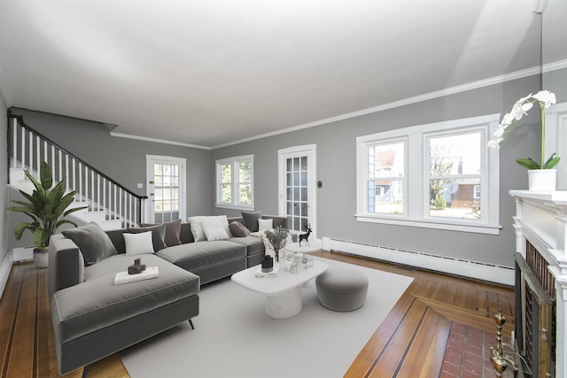 living room featuring a baseboard radiator, wood finished floors, stairs, and crown molding