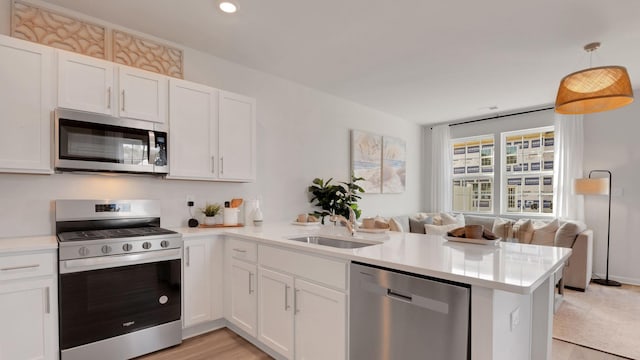 202 Bentz Ave Unit 0, Villas, NJ 08251 - kitchen with appliances with stainless steel finishes, a peninsula, a sink, open floor plan, and light countertops